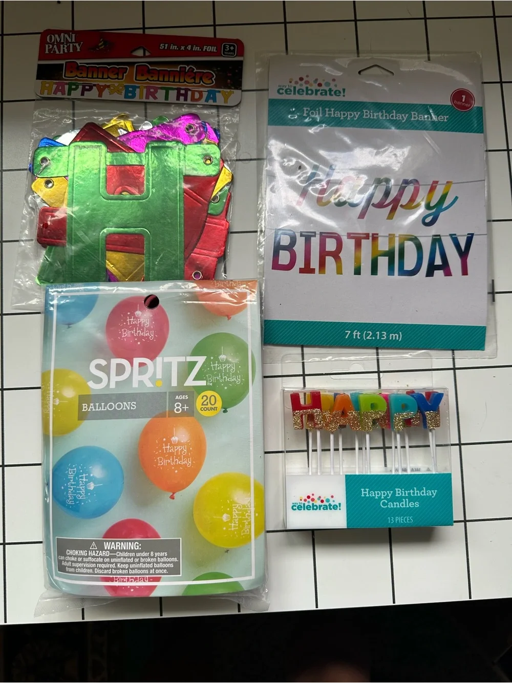 Colorful Birthday Bundle. 2 banners. 20 balloons. Candles spell HAPPY BIRTHDAY.